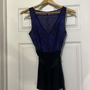 Beautiful purple and black top with silk tie waist. Like new